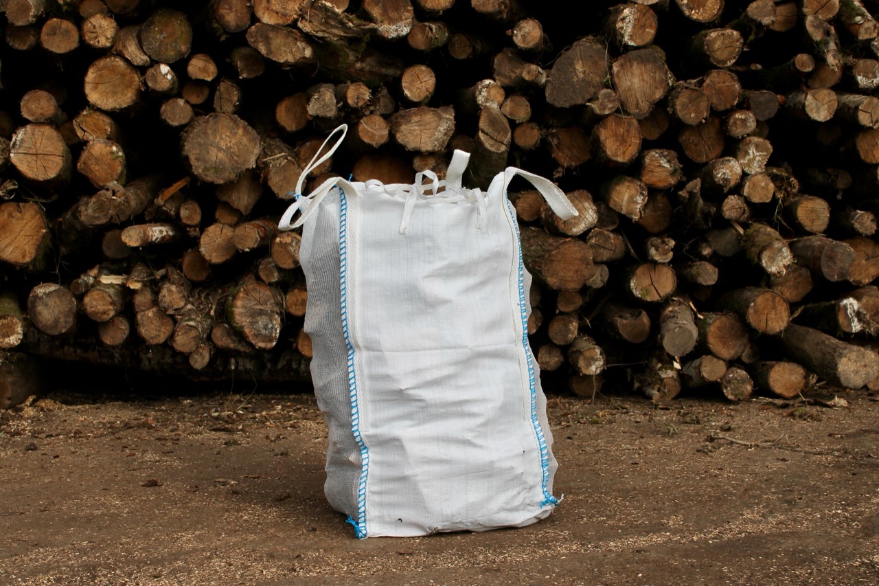 Woodham Nursery barrow bag in front of stacked timber